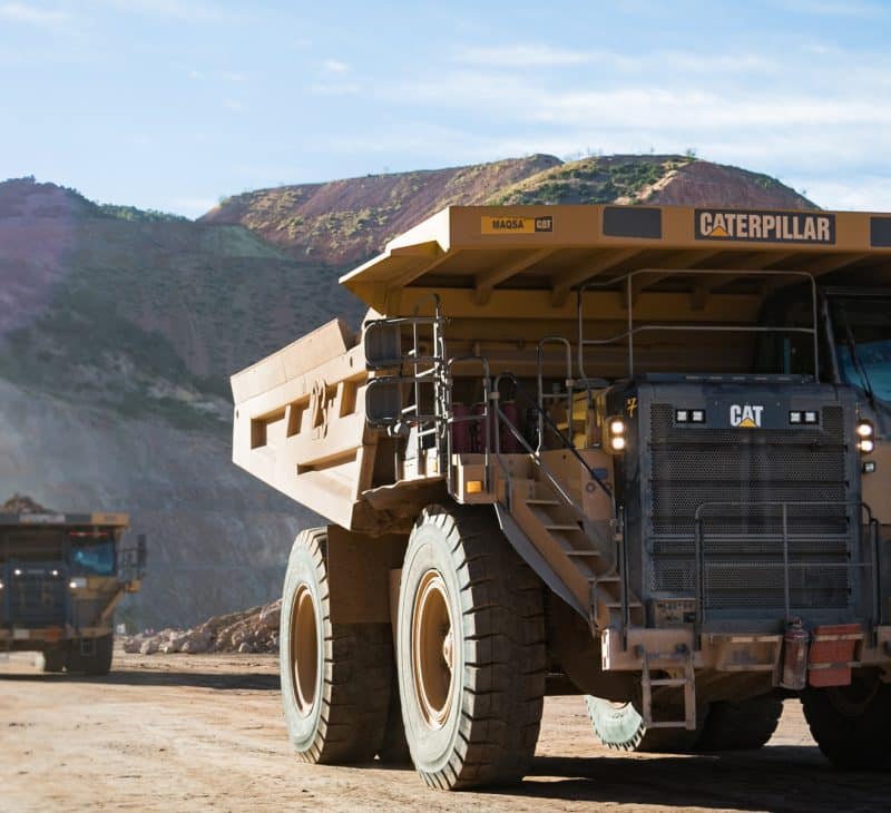 Three Mining Trucks on Site at Mining Operation